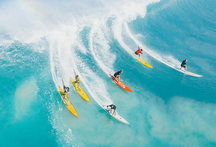 Surfers riding a nice wave , photo by jess loiterton, Pexels